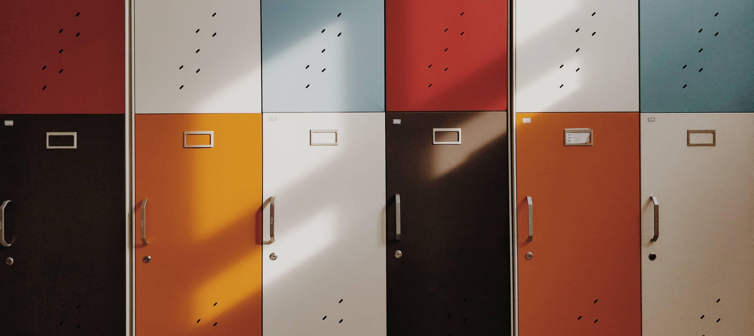 Multi-coloured lockers with shadows of windows