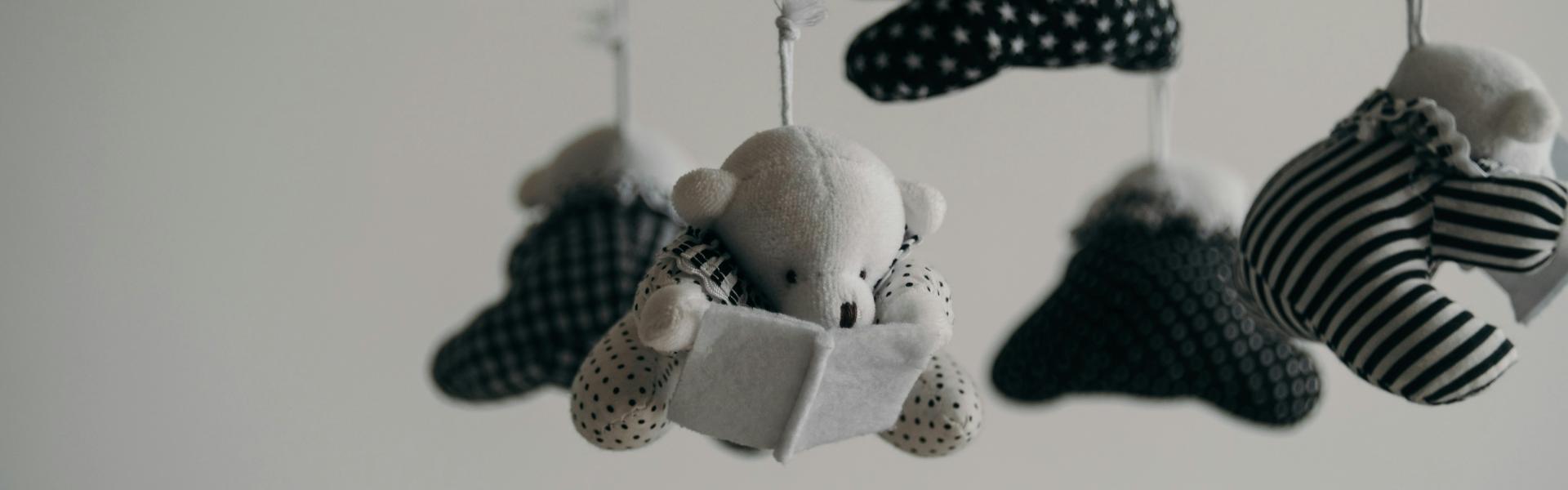 black and white baby mobile made of teddy bears