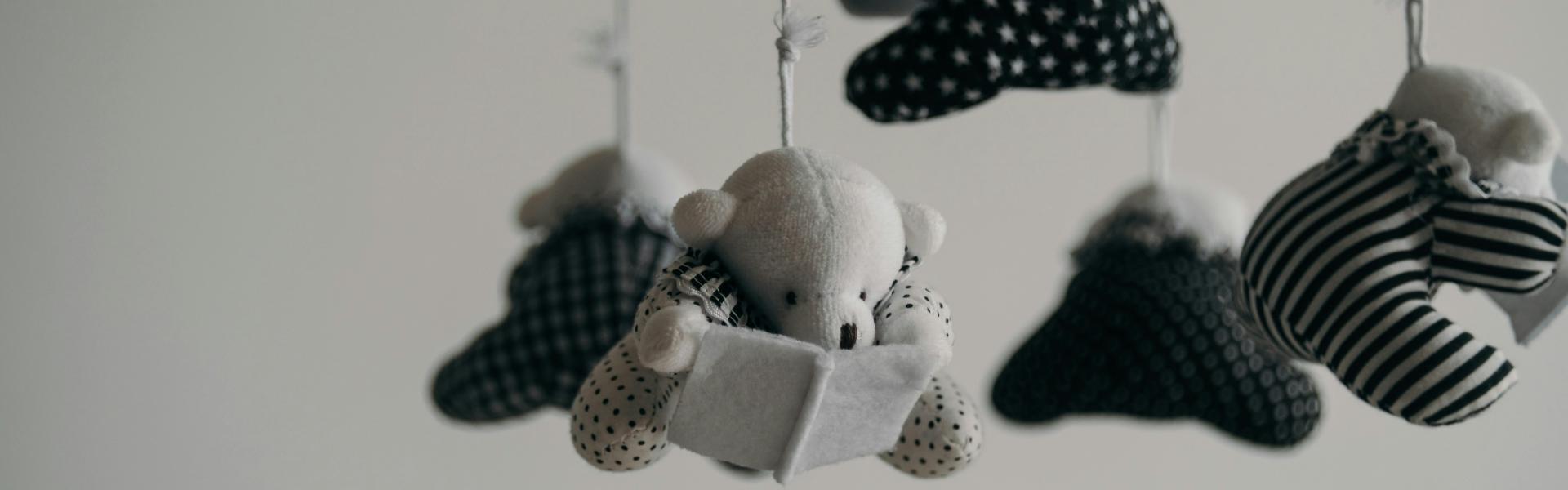 black and white baby mobile made of teddy bears